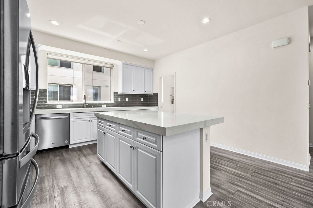 159 Steely Irvine, CA 92614 - Photo 7 of 30 Kitchen and dining area with oversized island and open-concept design ideal for entertaining.