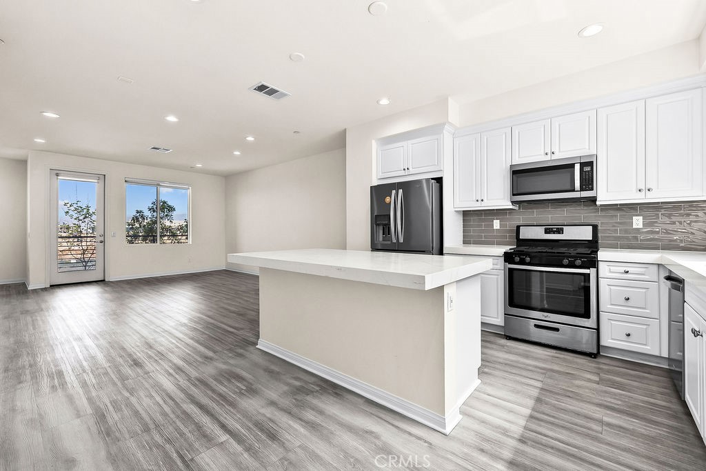 159 Steely Irvine, CA 92614 - Photo 29 of 30 Wide view of kitchen and living area highlighting open floor plan and natural light.