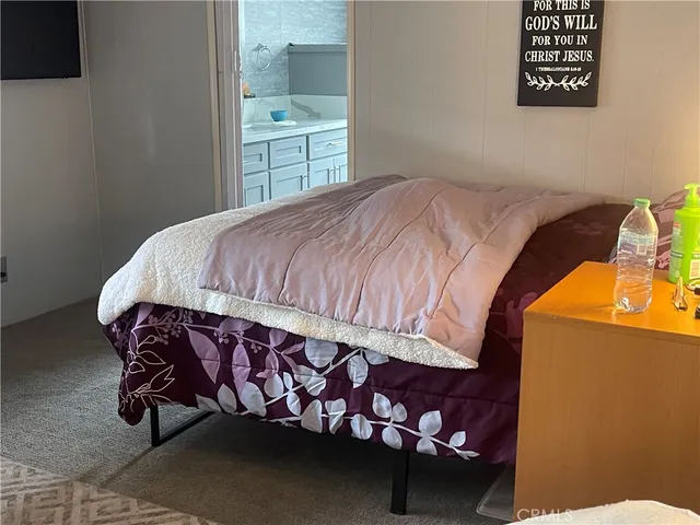 a bed sitting in a bedroom next to a window