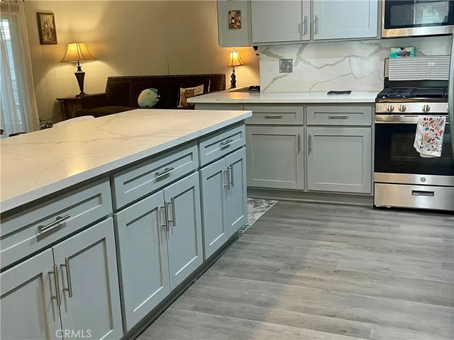 a kitchen with stainless steel appliances granite countertop a sink and cabinets