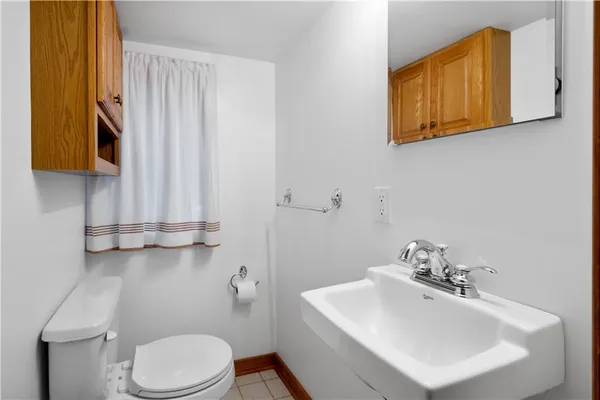 a bathroom with a sink a toilet and mirror