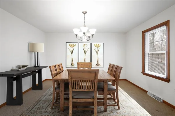 a view of a dining room with furniture window and outside view