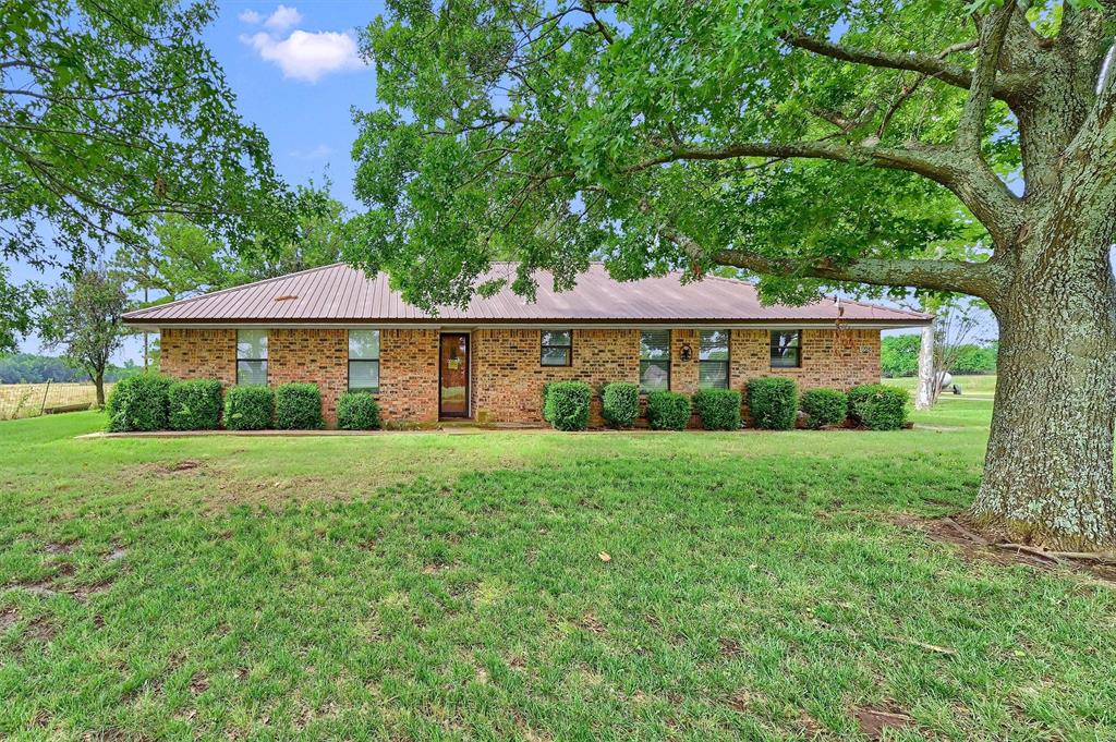 1730 Mackey Road Gunter, TX 75058 - Photo 18 of 21 a view of a bedroom with a yard and large tree