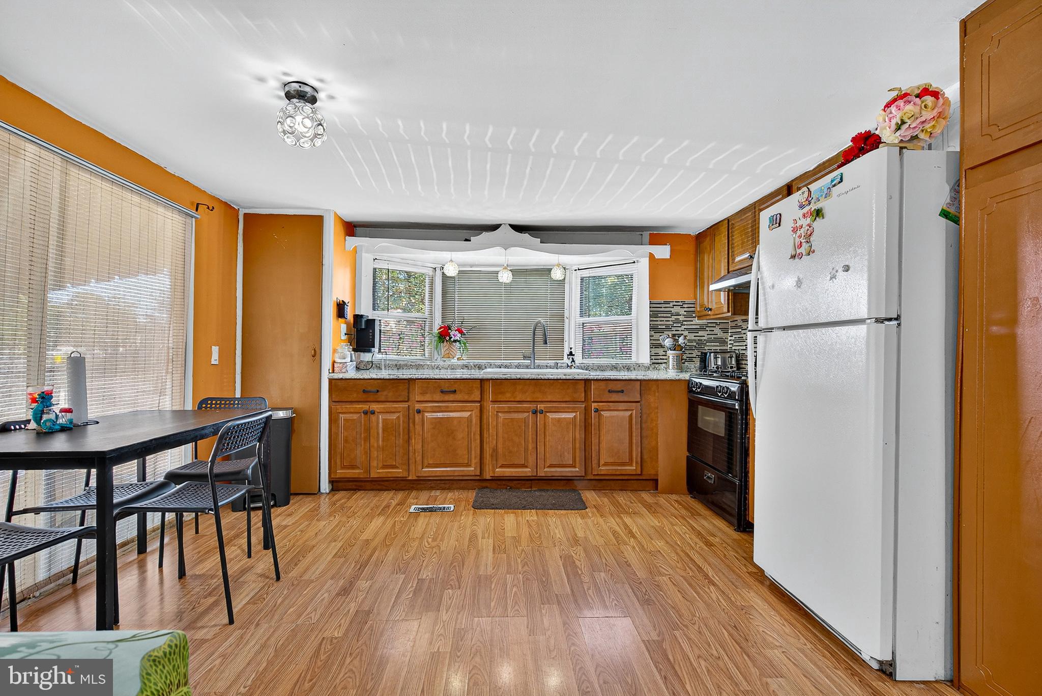 210 Trailway Road Middle River, MD 21220 - Photo 3 of 17 a kitchen with a table chairs refrigerator and cabinets