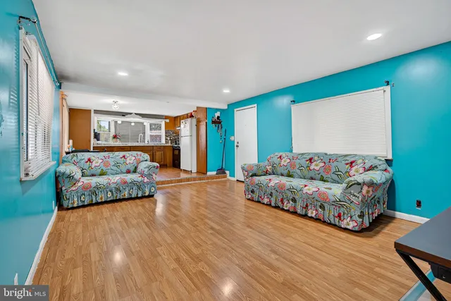 a bedroom with furniture and a wooden floor