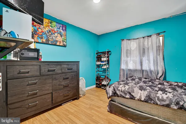 a bedroom with a bed and a painting on the wall