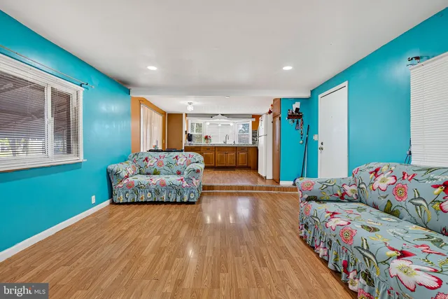 a bedroom with furniture and a wooden floor