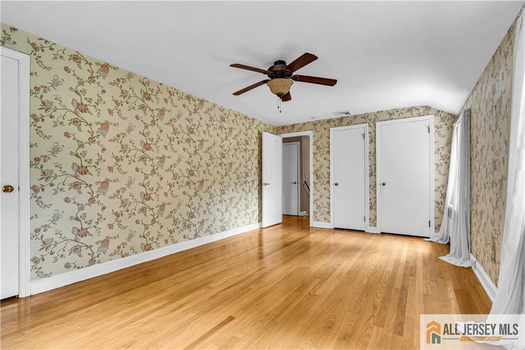 20 Oak Hills Road Edison, NJ 08820 - Photo 23 of 41 a view of a livingroom with wooden floor and a ceiling fan