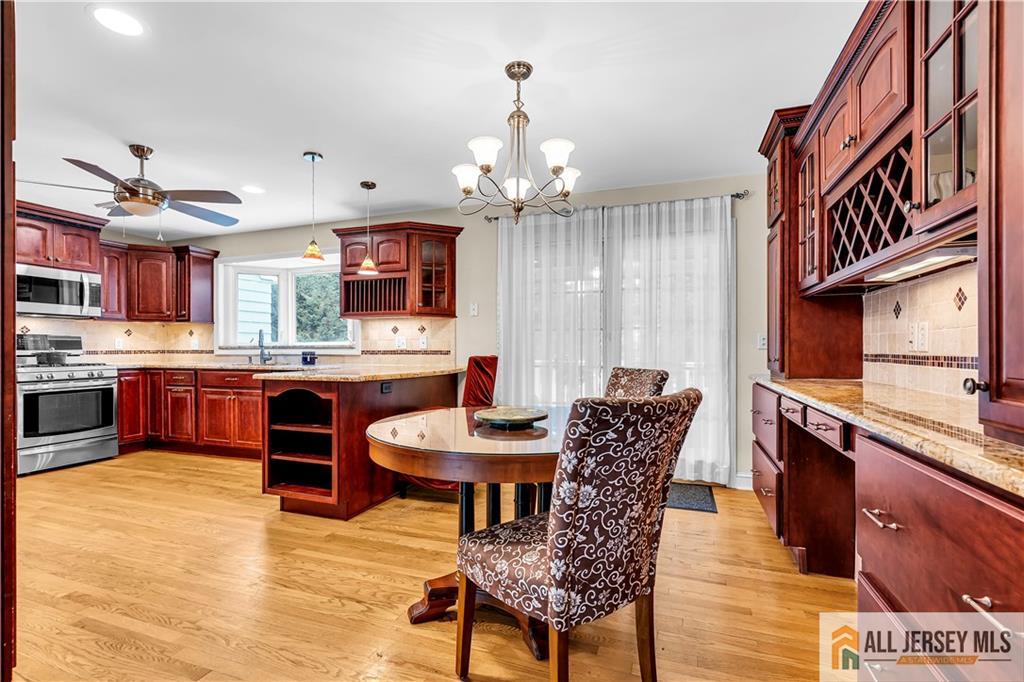20 Oak Hills Road Edison, NJ 08820 - Photo 3 of 41 a dining room with furniture a kitchen and chandelier