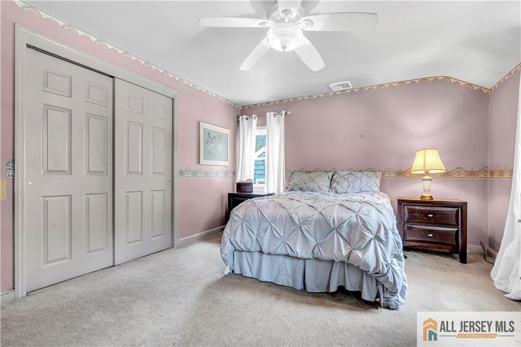 20 Oak Hills Road Edison, NJ 08820 - Photo 33 of 41 a bedroom with a bed and a chandelier