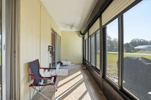 a view of a room with furniture and floor to ceiling window