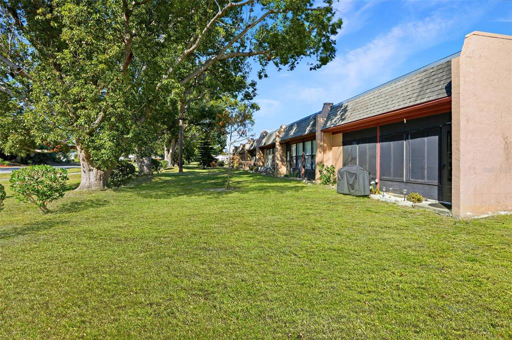 11203 Pembridge Court, Unit 1 Port Richey, FL 34668 - Photo 21 of 32 a view of a house with a yard
