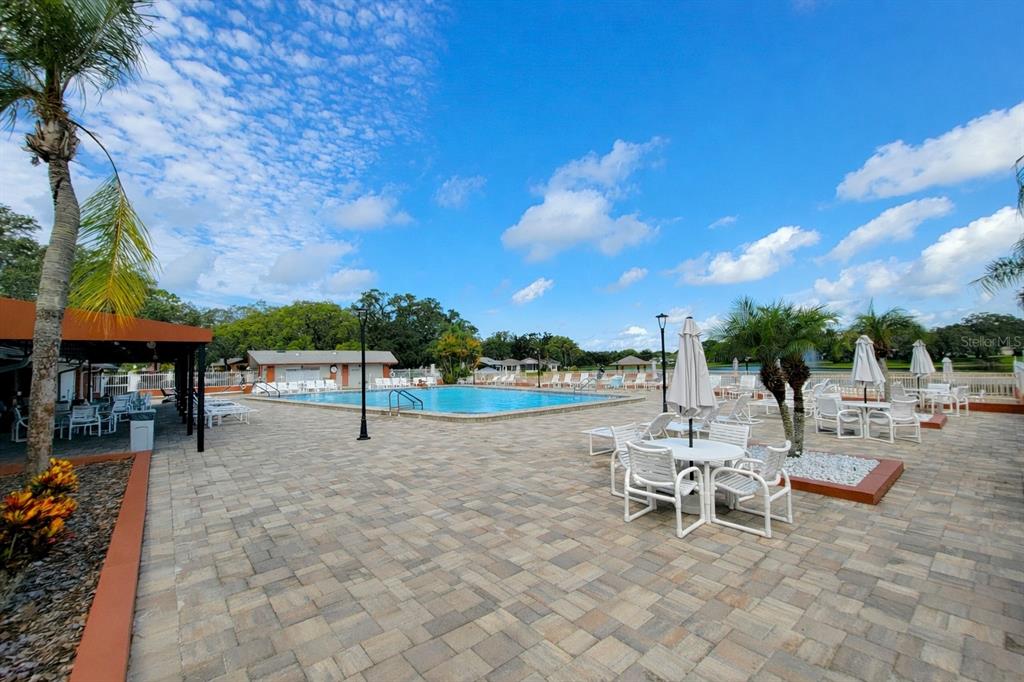 11203 Pembridge Court, Unit 1 Port Richey, FL 34668 - Photo 23 of 32 a view of a terrace with sitting area