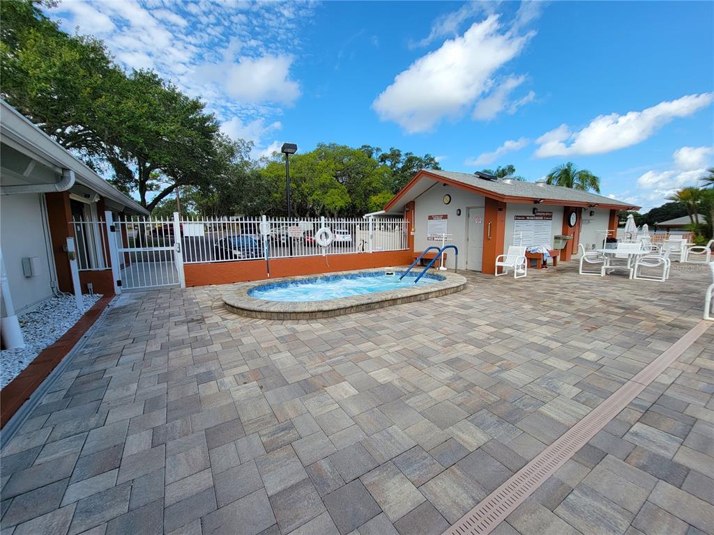 11203 Pembridge Court, Unit 1 Port Richey, FL 34668 - Photo 24 of 32 a view of a house with backyard and trees