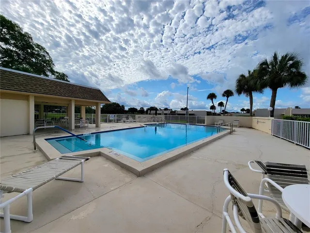 a swimming pool with outdoor seating and yard