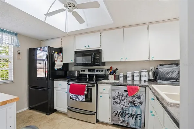 a kitchen with stainless steel appliances granite countertop a refrigerator stove and sink