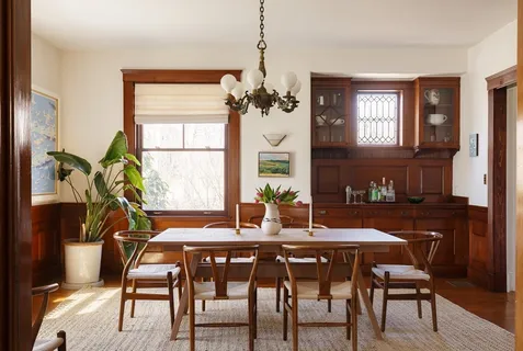 a dining room with furniture a chandelier and wooden floor