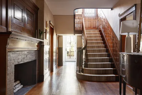 a view of entryway and hall with wooden floor