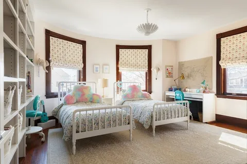 a bedroom with a bed and a book shelf