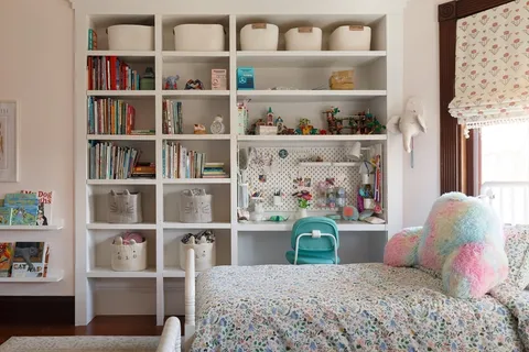 a bedroom with a bed and dresser with mirror