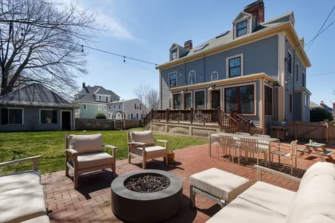 a view of a chairs and table in a backyard