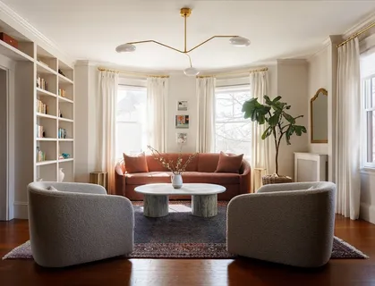 a living room with furniture a large window and a chandelier