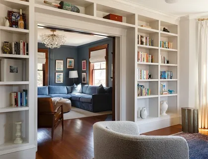 a living room with furniture and a book shelf