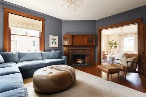 a living room with furniture and a fireplace
