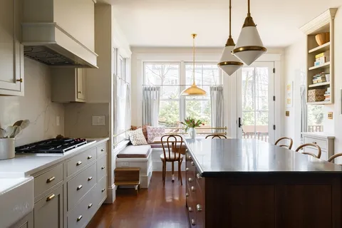 a open kitchen with stainless steel appliances granite countertop a stove and white cabinets