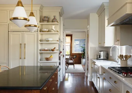 a kitchen with stainless steel appliances granite countertop a refrigerator a stove and a sink