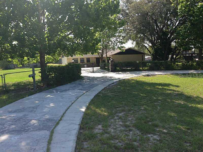 15440 Hays Road Spring Hill, FL 34610 - Photo 1 of 1 a view of a backyard with large trees