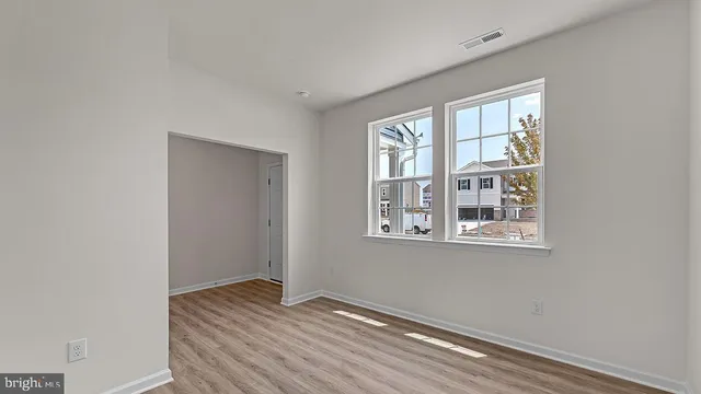 a view of room with window and wooden floor