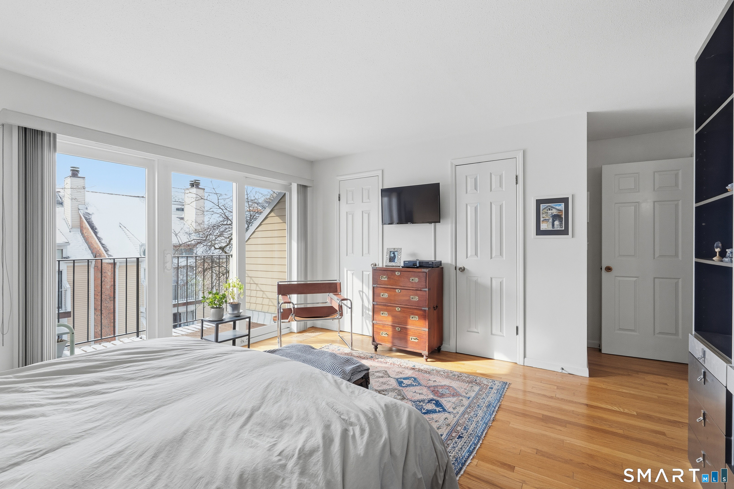 91 Highland Road, Unit 91 Stamford, CT 06901 - Photo 12 of 15 a bedroom with a bed and a television