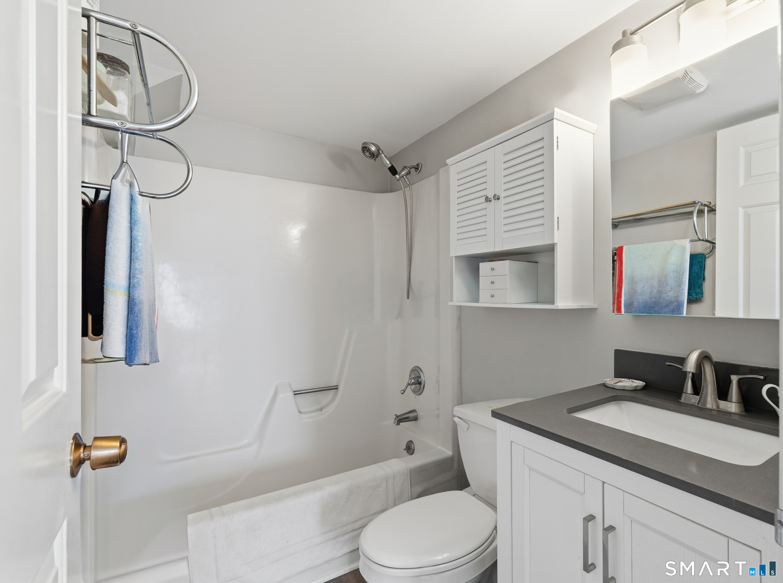 91 Highland Road, Unit 91 Stamford, CT 06901 - Photo 13 of 15 a bathroom with a granite countertop sink toilet and shower