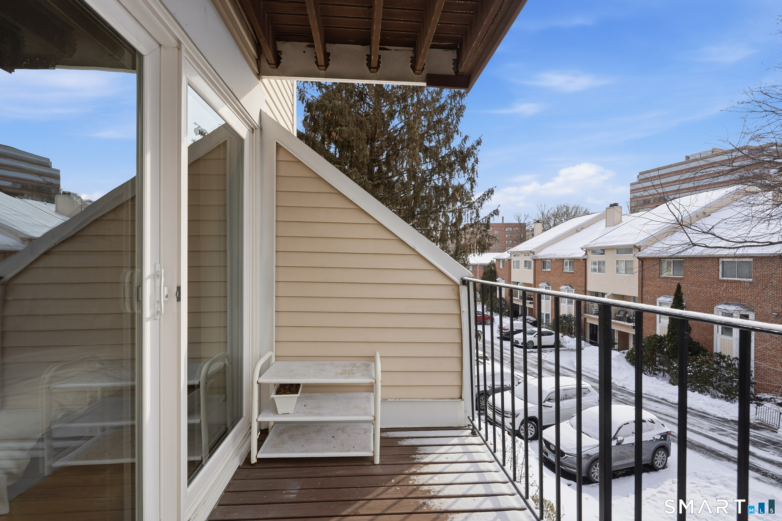 91 Highland Road, Unit 91 Stamford, CT 06901 - Photo 14 of 15 a view of a balcony with wooden floor and fence