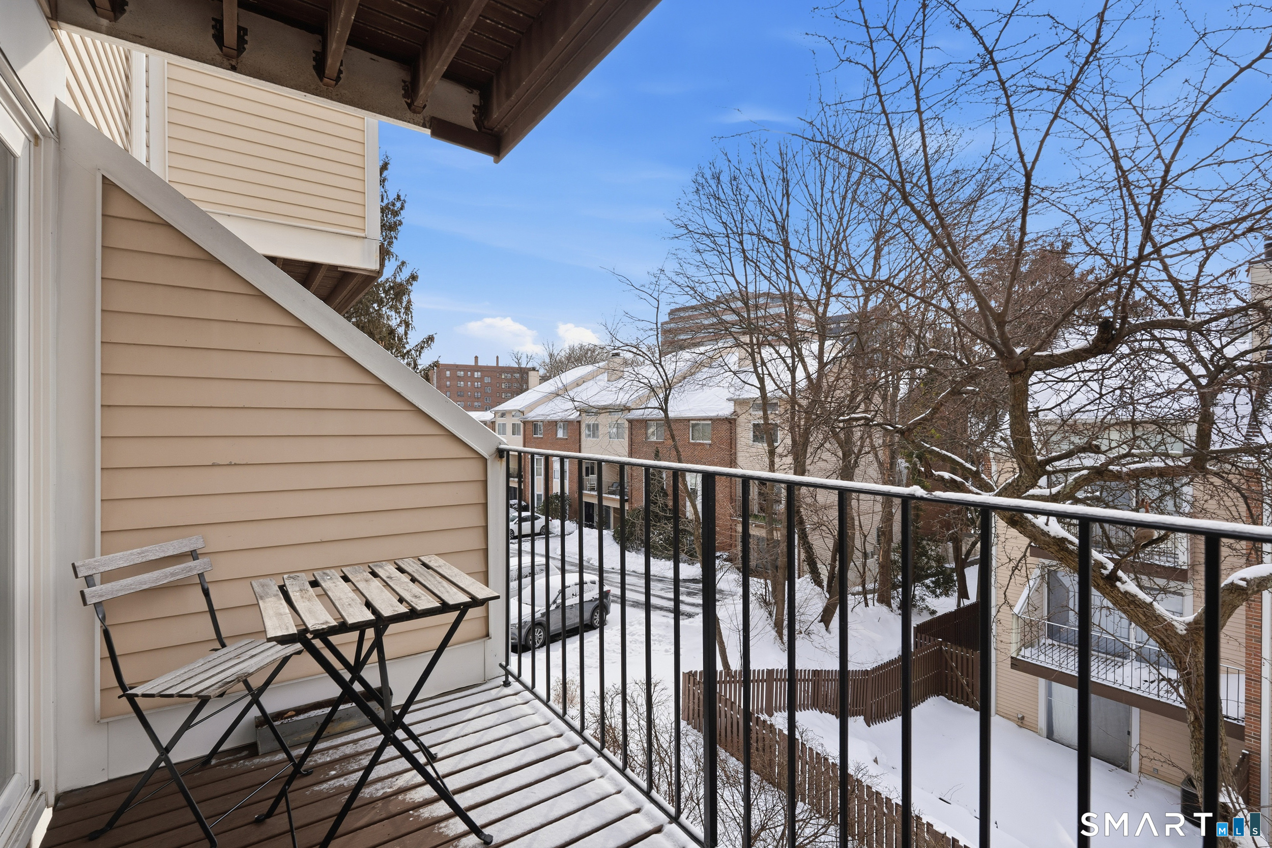 91 Highland Road, Unit 91 Stamford, CT 06901 - Photo 9 of 15 a view of a balcony with wooden floor and fence