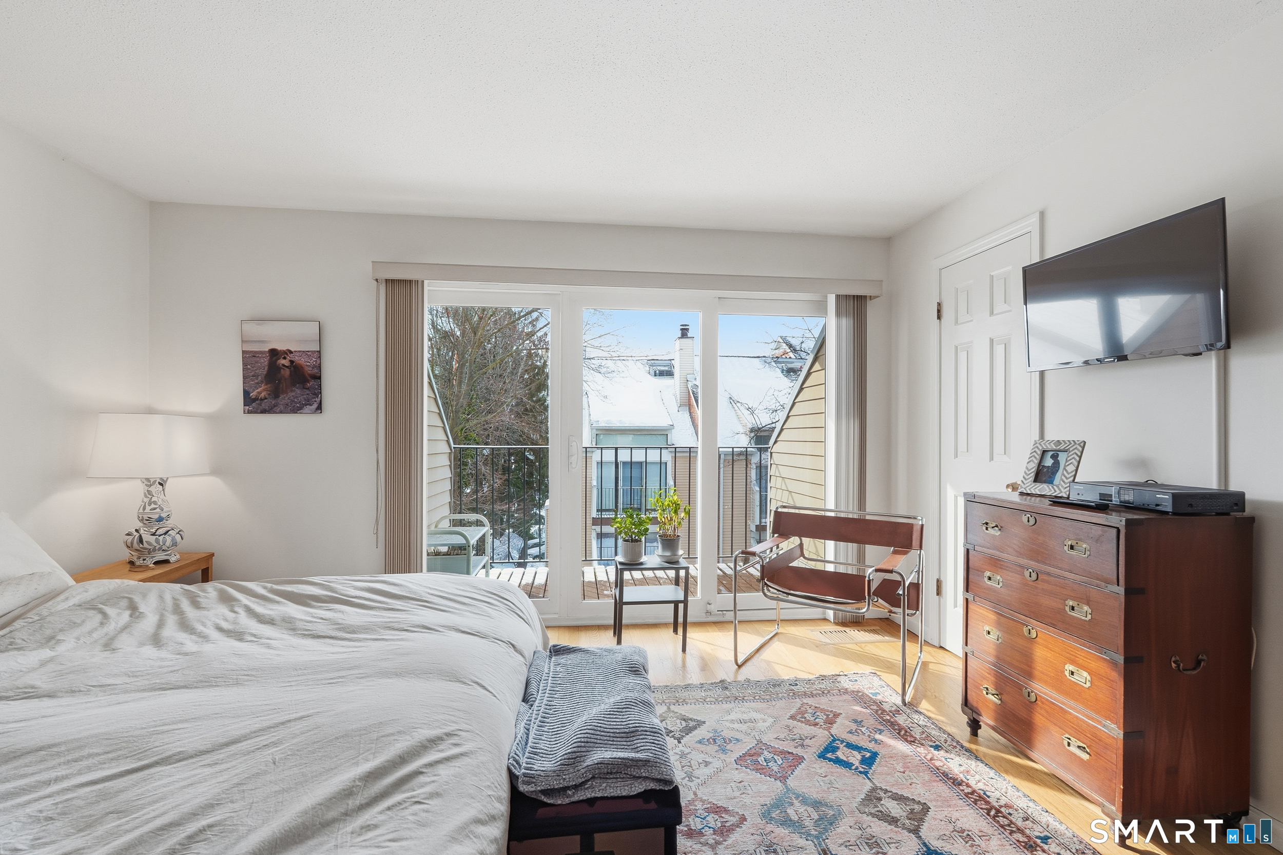 91 Highland Road, Unit 91 Stamford, CT 06901 - Photo 10 of 15 a bedroom with a bed and large windows