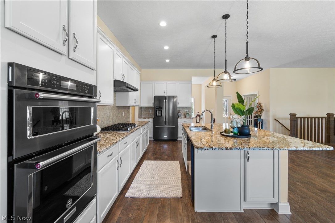 535 East Caston Road Green, OH 44685 - Photo 3 of 44 Amazing open kitchen with high end appliances, granite island, pendant lighting and 10 ft ceilings