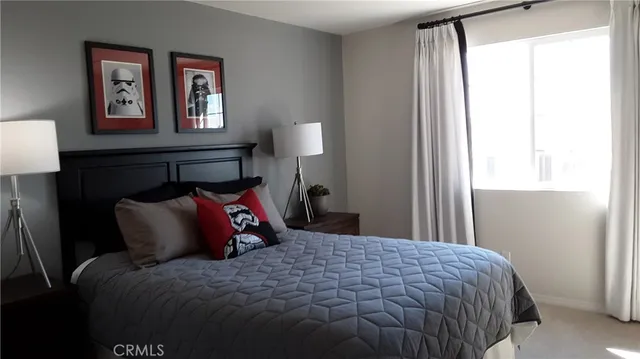 a bedroom with a bed and a lamp