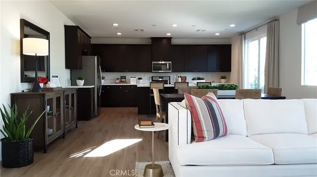 a living room with lots of furniture and kitchen view