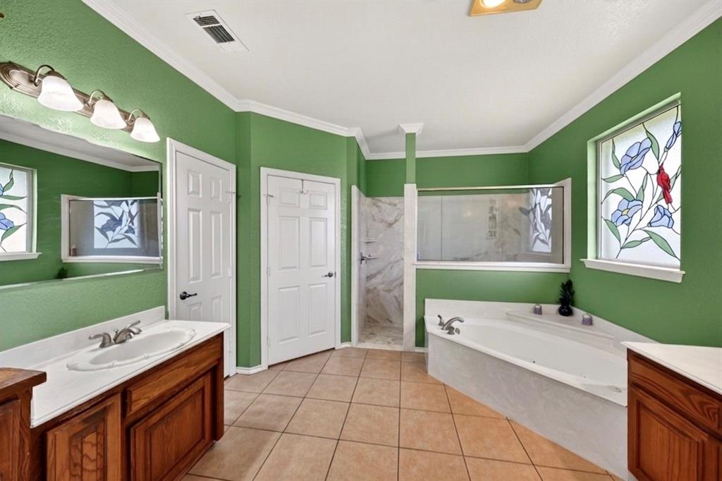 1035 Highland Road Cleburne, TX 76033 - Photo 20 of 36 a bathroom with a bath tub sink and mirror