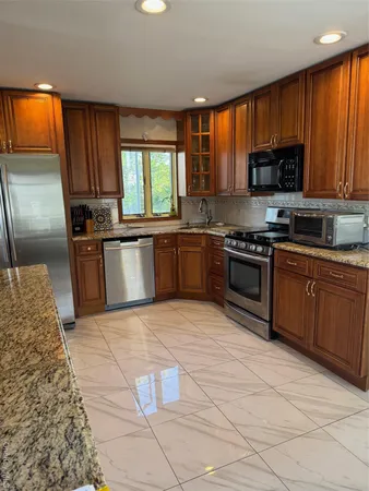 a kitchen with stainless steel appliances granite countertop a stove granite counter tops and a stove top oven