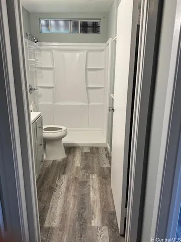 a bathroom with a toilet and a shower