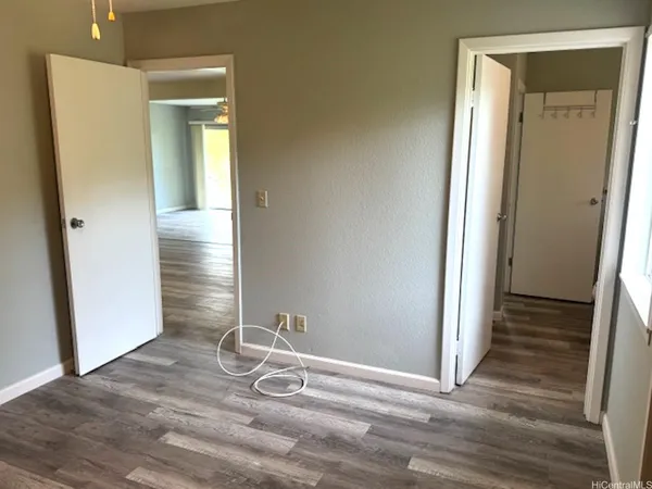 a view of a livingroom with wooden floor and closet