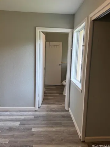 a view of a hallway with wooden floor