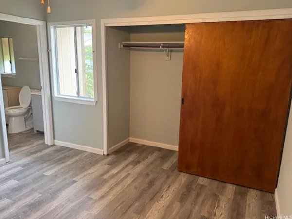 a view of a room with wooden floor and bathroom