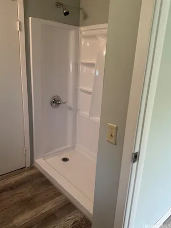 a bathroom with a glass door shower