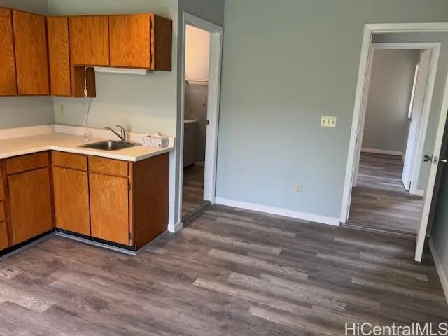 a kitchen with stainless steel appliances granite countertop a sink and a refrigerator