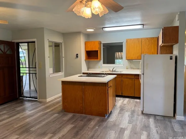 a kitchen with stainless steel appliances granite countertop a refrigerator a sink dishwasher a stove with wooden floor and cabinets