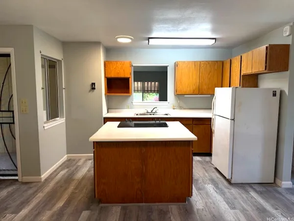 a kitchen with refrigerator a stove a sink and a refrigerator